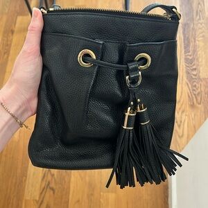 Black leather cross body Michael Kors purse with tassels